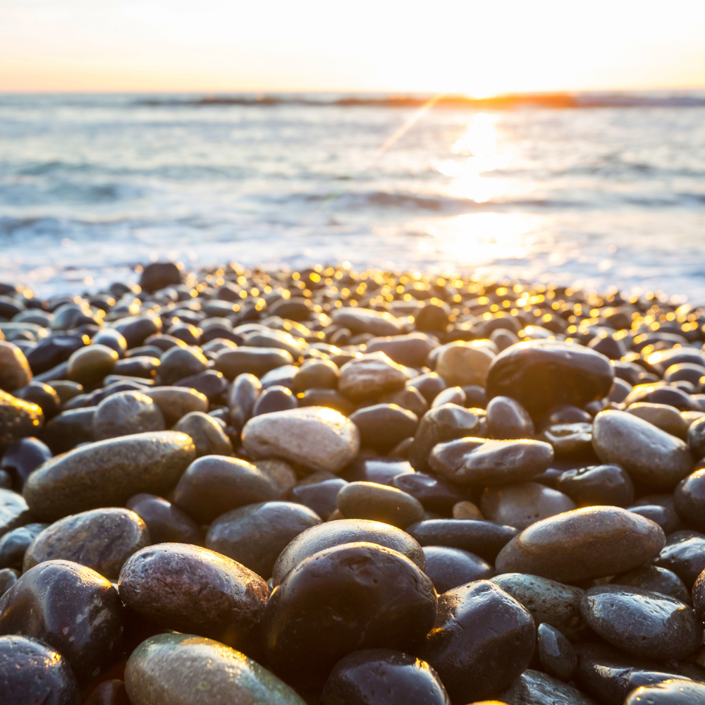 Smooth pebbles by sea representing grounding and holistic healing